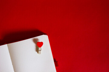 dotted notepad on red background with heart for inscriptions and notes