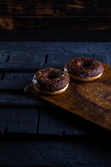 Donuts on a wooden board on a blue concrete background