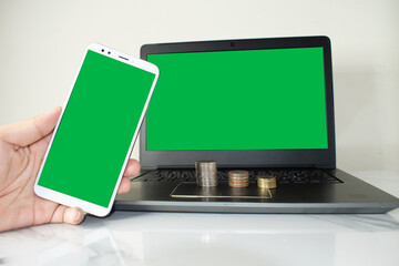mockup image blank screen computer,cell phone with space for advertising text,hand using laptop texting mobile contact business searching information in workplace desk in office.design creative work