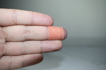 Close up of injured finger with finger plaster adhesive-image