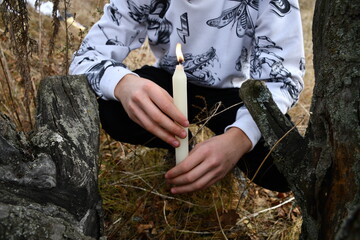 person with a candle in the forest