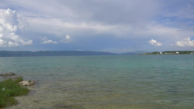 Beautiful Sevan lake in Armenia on Mountains and Clouds background. 