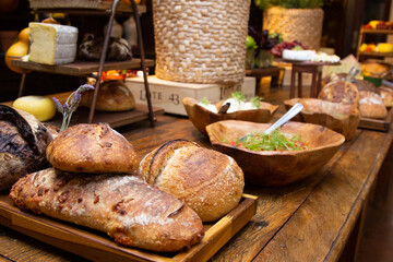 Obraz na płótnie Canvas Homemade breads exposed on wooden table