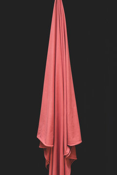 Detail of draped fabric, focus on folds and creases with black background