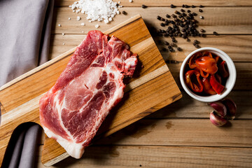 raw meat steak on a wooden board