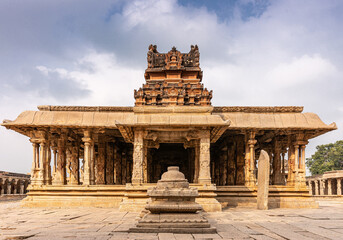 Hampi, Karnataka, India - November 5, 2013: Sri Krishna temple in ruins. Red stone vimanam on top...