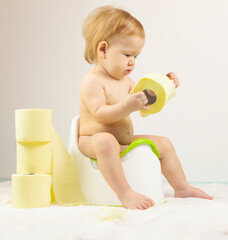 baby sits on a baby potty. Children's hygiene. Potty training.