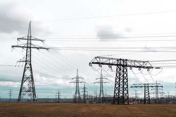 Electricity pylons conducting current from distribution power station, solar renewable energy and...