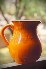 Orange jug for milk or juice. Kitchen accessories.