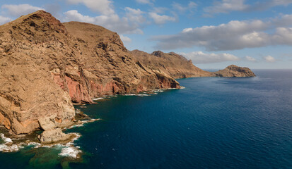 Fototapeta premium The wild east coast of the Spanish Atlantic island of Tenerife. An aerial view of the interesting rock top in summer with sunshine and blue skies.
