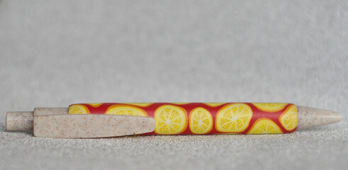 ballpoint pen covered with polymer clay lemon and orange pattern