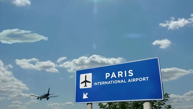 Jet airplane landing in Paris France. City arrival with airport direction sign. Travel, business, tourism and transport concept.