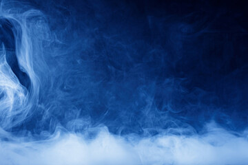 Abstract blue smoke moves on black background. Swirling smoke.
