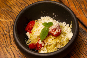 Spaghetti from pupunha with pesto and goat cheese.