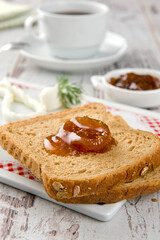 Delicious Fig Jam whit slice of bread for Breakfast on white wooden table.