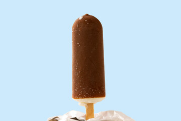 Close up view of ice cream in chocolate glaze on blue  background.