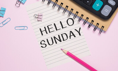 Notepad with text Hello Sunday on white background with clips, pen and magnifying glass. Can be use as concept photo