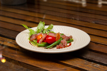 Nicoise salad - salad made with arugula, chopped tomatoes and anchovies.