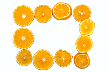Dried slices of orange isolated on white background,  frame.  Selective focus, top view.