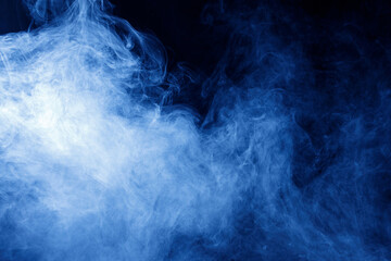 Abstract blue smoke moves on black background. Swirling smoke.