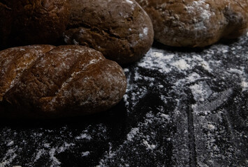 Fototapeta na wymiar bread and flour on black background 