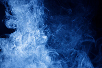 Abstract blue smoke moves on black background. Swirling smoke.