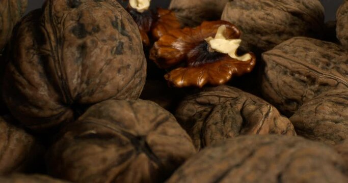 Close Up Pile Of Organic And Fresh Walnuts. Camera Moves Close-up Among Piles of Fresh Walnuts.