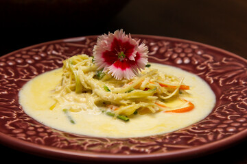 Vegetable noodles in white sauce.