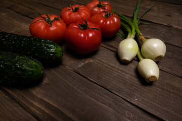 cucumber, tomato, green onion and parsley on wooden board