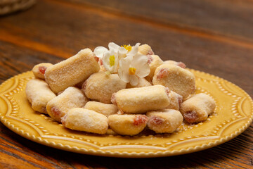 Traditional Brazilian guava paste cookies called goiabinha on wooden table.