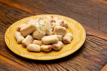 Traditional Brazilian guava paste cookies called goiabinha on wooden table.
