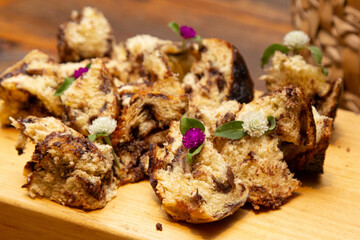 Delicious slices of panettone with candied fruit on the wooden board.