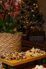 Delicious slices of panettone with candied fruits on the wooden board with christmas background
