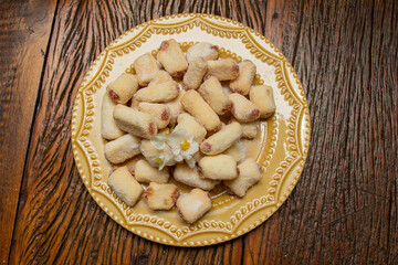 Traditional Brazilian guava paste cookies called goiabinha on wooden table.