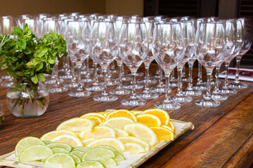 Lemons cut into slices, at the bottom sparkling glasses.