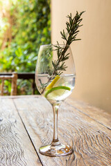 Drink in a bowl with lemon and rosemary.