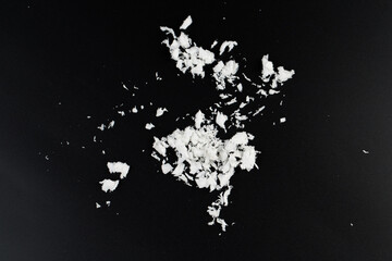 white artificial synthetic snow on black background