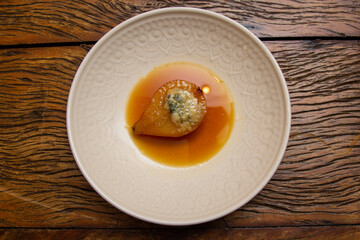 Dessert Pear Brulee stuffed with Gorgonzola cheese