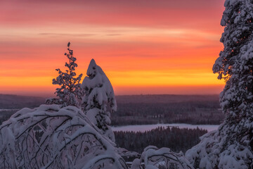 Sunset in snowy mountains in winter wonderland lapland