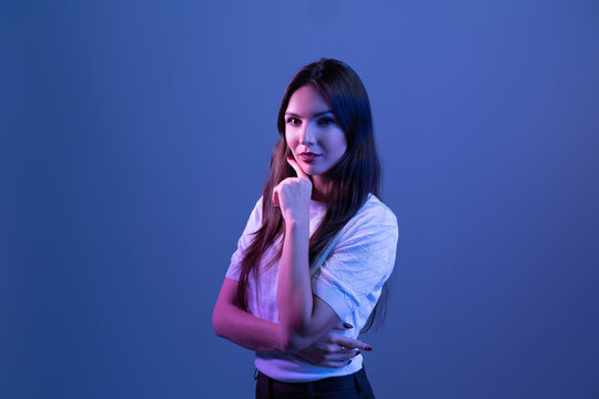 Happy Business Woman Standing On Neon Studio Background. Beautiful Female  Portrait.