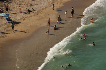 crowd of people on the beach taken from the air