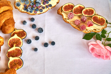 Croissant toast with butter and figs. French dip sandwich with berries raspberries for Breakfast. High quality photo