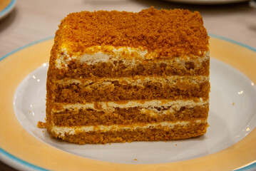 A piece of homemade Russian Medovik layer cake made with  honey and smetana (sour cream) or condensed milk in Saint Petersburg, Russia