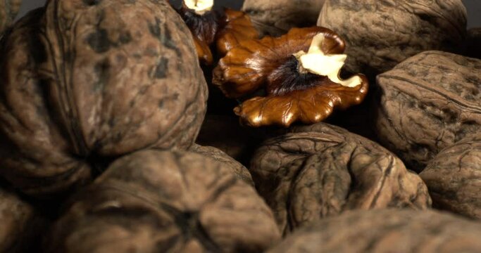 Close Up Pile Of Organic And Fresh Walnuts. Camera Moves Close-up Among Piles of Fresh Walnuts.