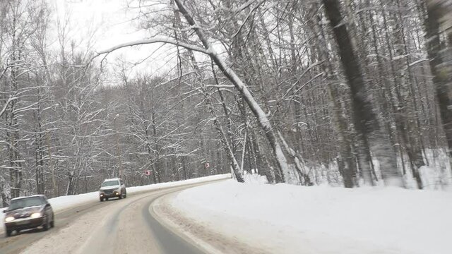 Winter Driving Curvy Snowy Country Road Curvy snowy country road leading through a forest mountain landscape
