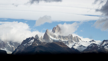 Asphalted road with the peaks of a rocky and snowy mountain on the horizon. Fitz Roy mountain in Argentina horizontal Photograph