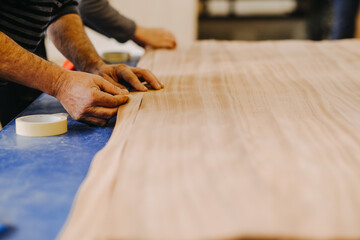 Closeup shot of a worker laying parquet boards