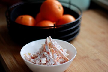 Candied oranges in powder.  Sweet oranges. Sweet dried oranges in a plate on the table.