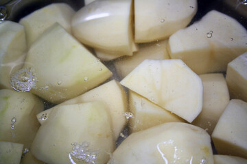 Potatoes cut into pieces in water.