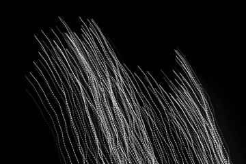 white dashed lines of lights on a black background